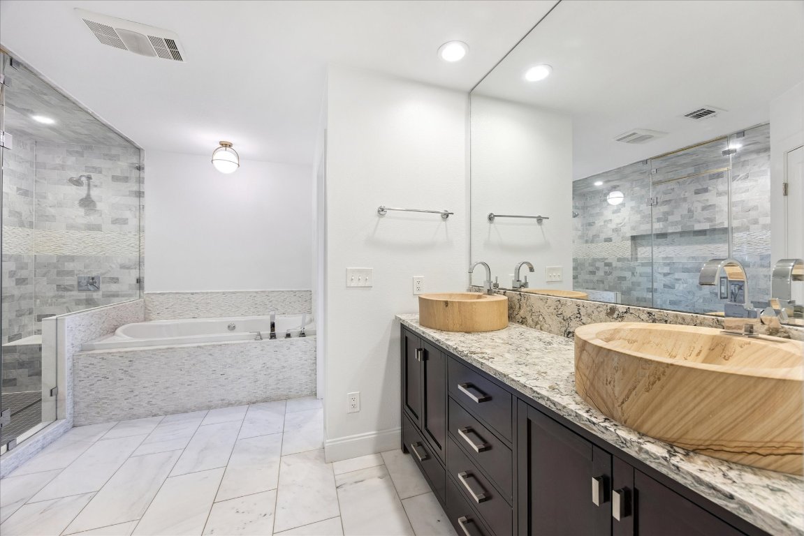 1106 Fairmount Avenue Austin, TX 78704 - Photo 13 of 25 a spacious bathroom with a granite countertop tub sink and mirror