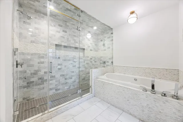 a bathroom with a bathtub and shower