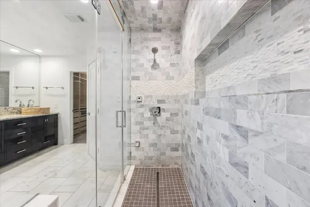 a bathroom with a shower and a sink