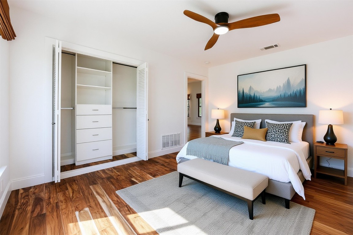 a spacious bedroom with a bed and a chandelier