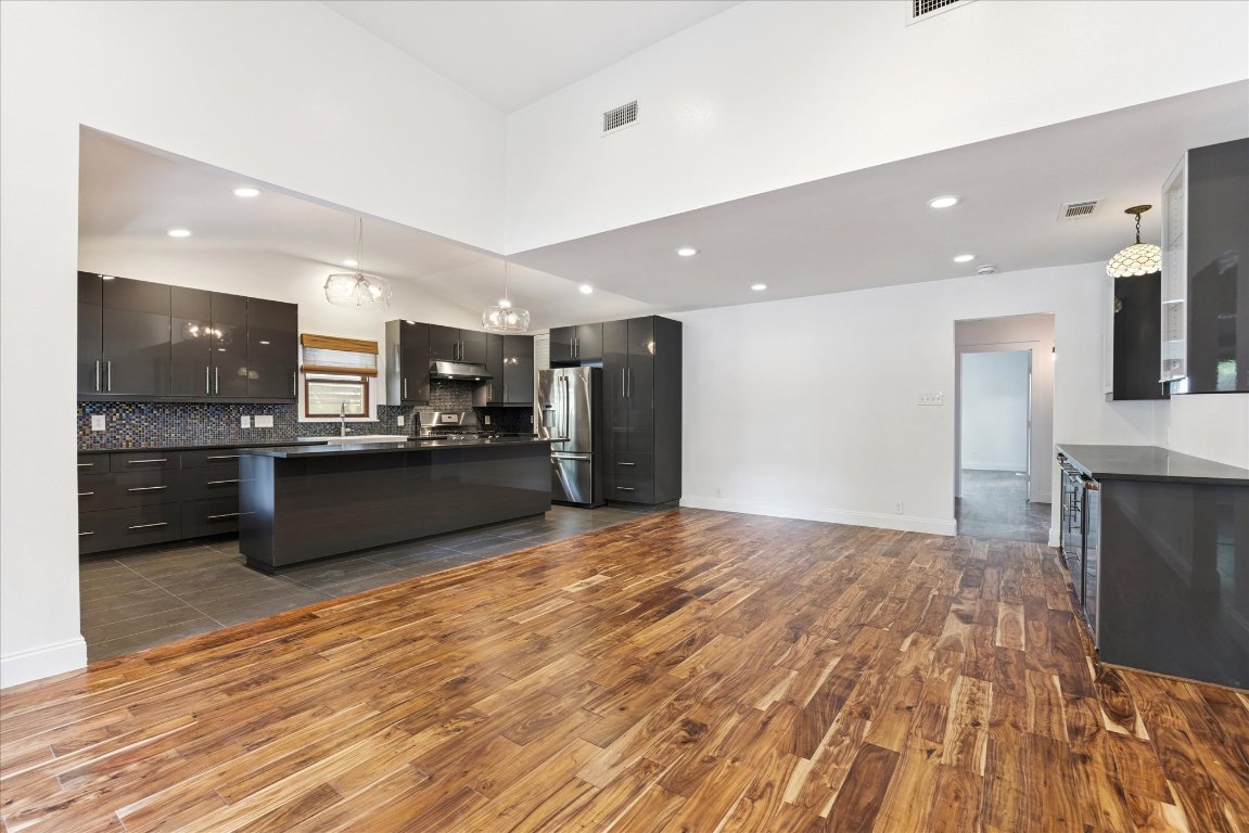 1106 Fairmount Avenue Austin, TX 78704 - Photo 6 of 25 a large kitchen with kitchen island a sink stainless steel appliances and cabinets