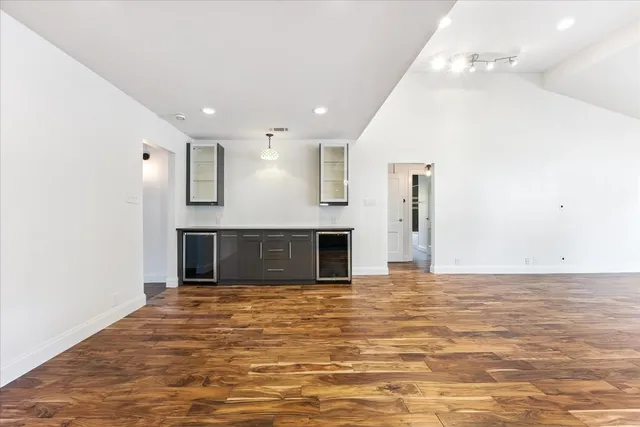 a large kitchen with kitchen island a sink stainless steel appliances and cabinets