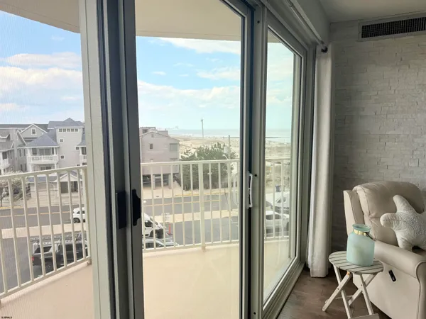 a view of a balcony with chair and door