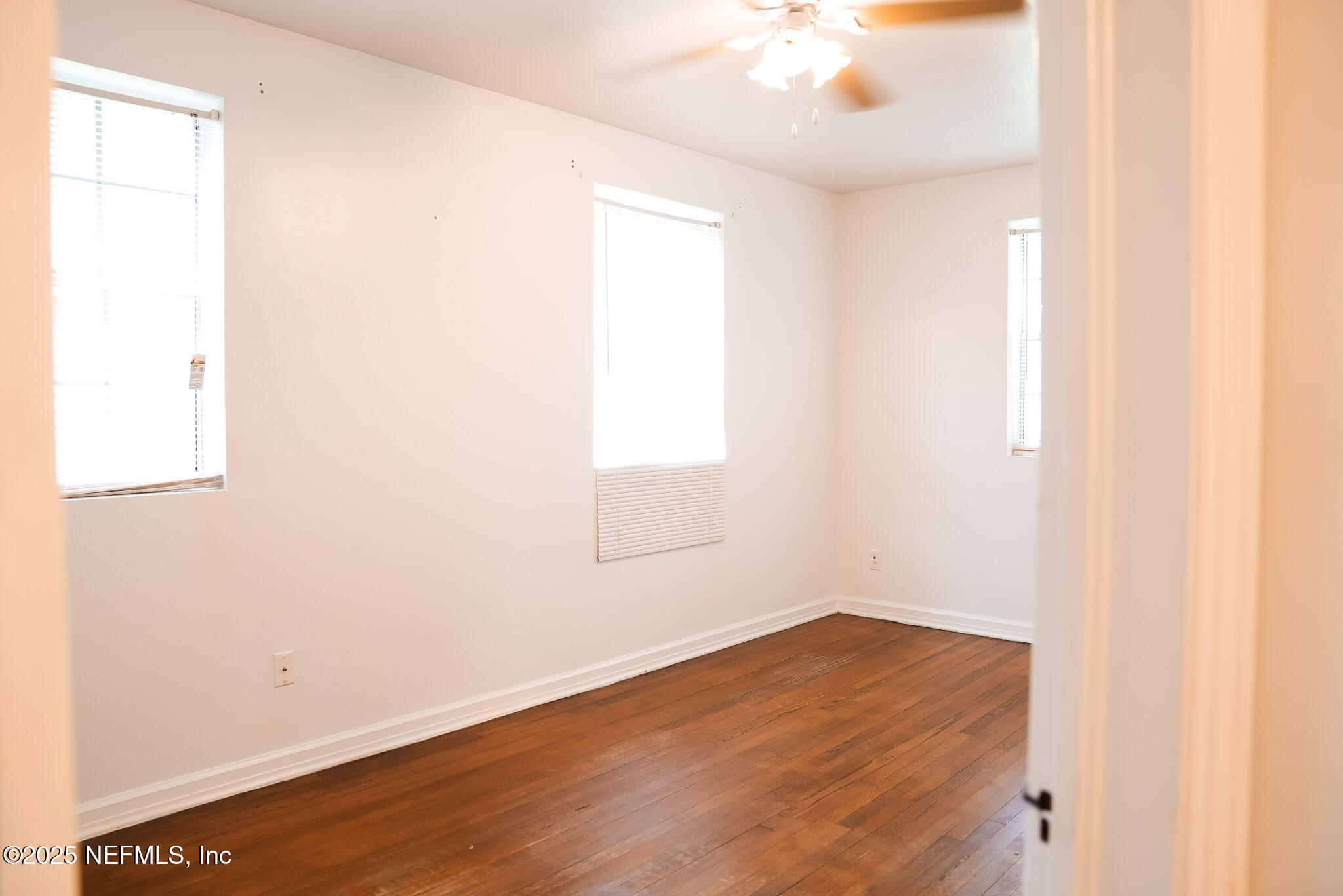 3224 Claremont Road Jacksonville, FL 32207 - Photo 12 of 26 an empty room with wooden floor and windows