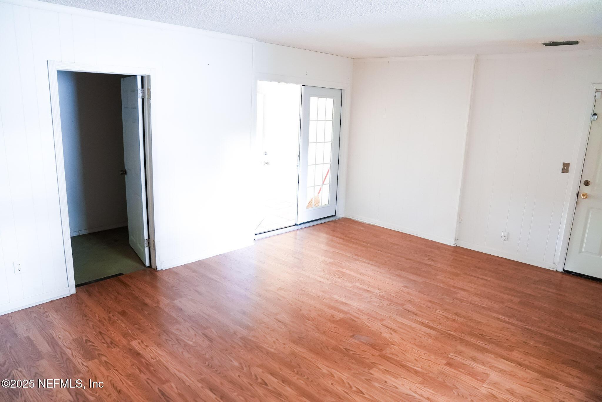 3224 Claremont Road Jacksonville, FL 32207 - Photo 23 of 26 an empty room with wooden floor and closet