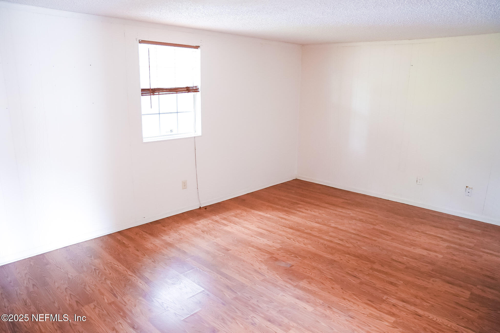 3224 Claremont Road Jacksonville, FL 32207 - Photo 24 of 26 an empty room with wooden floor and windows