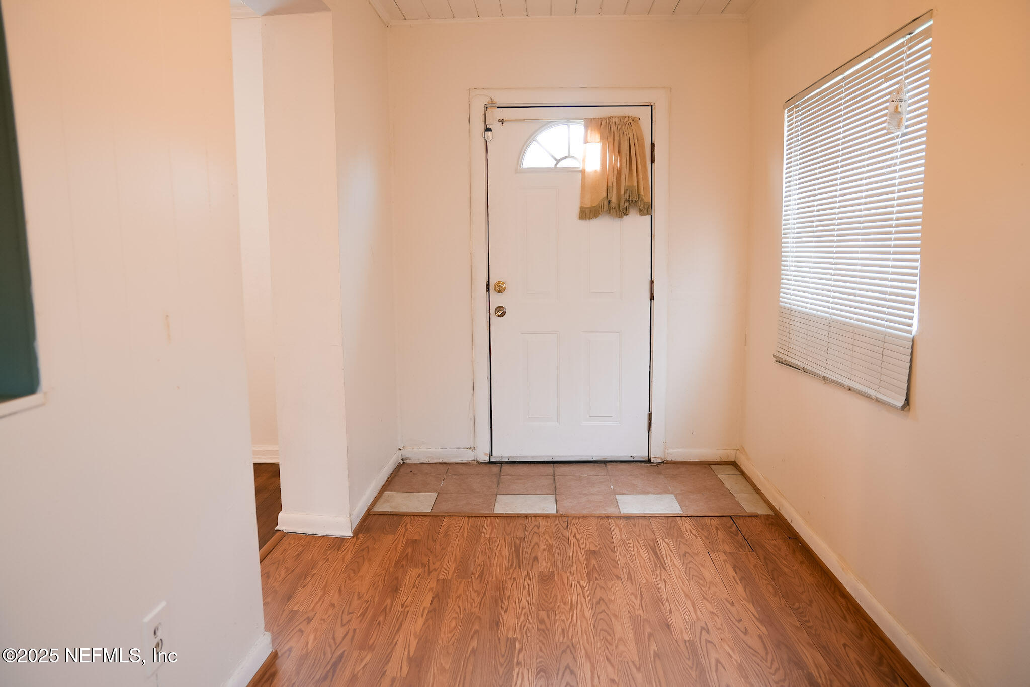 3224 Claremont Road Jacksonville, FL 32207 - Photo 3 of 26 an empty room with wooden floor and windows