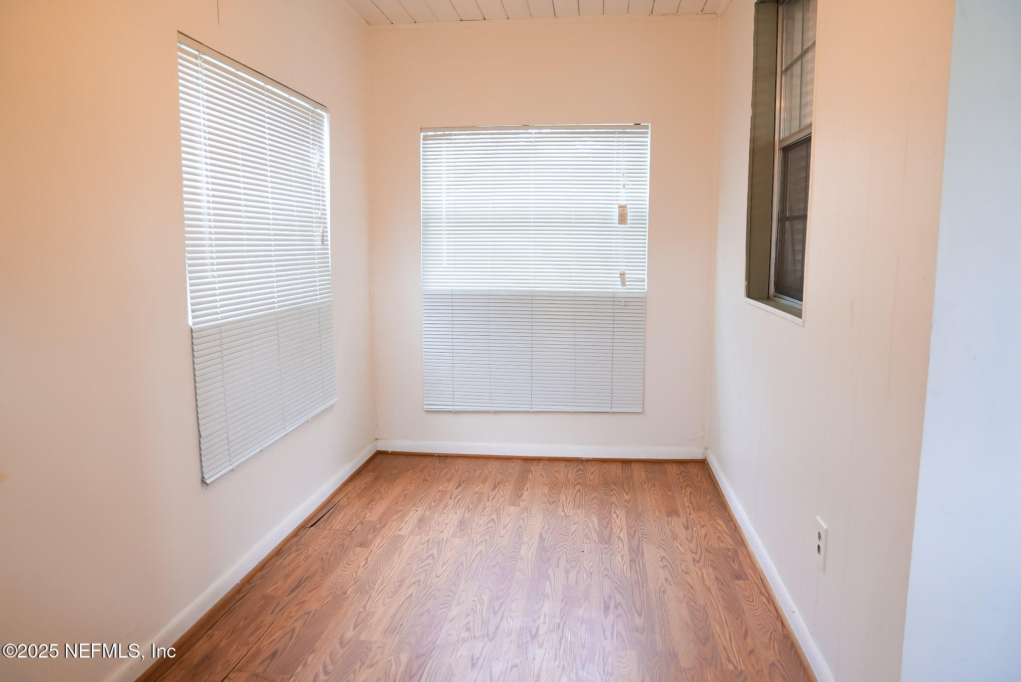 3224 Claremont Road Jacksonville, FL 32207 - Photo 4 of 26 an empty room with wooden floor and windows
