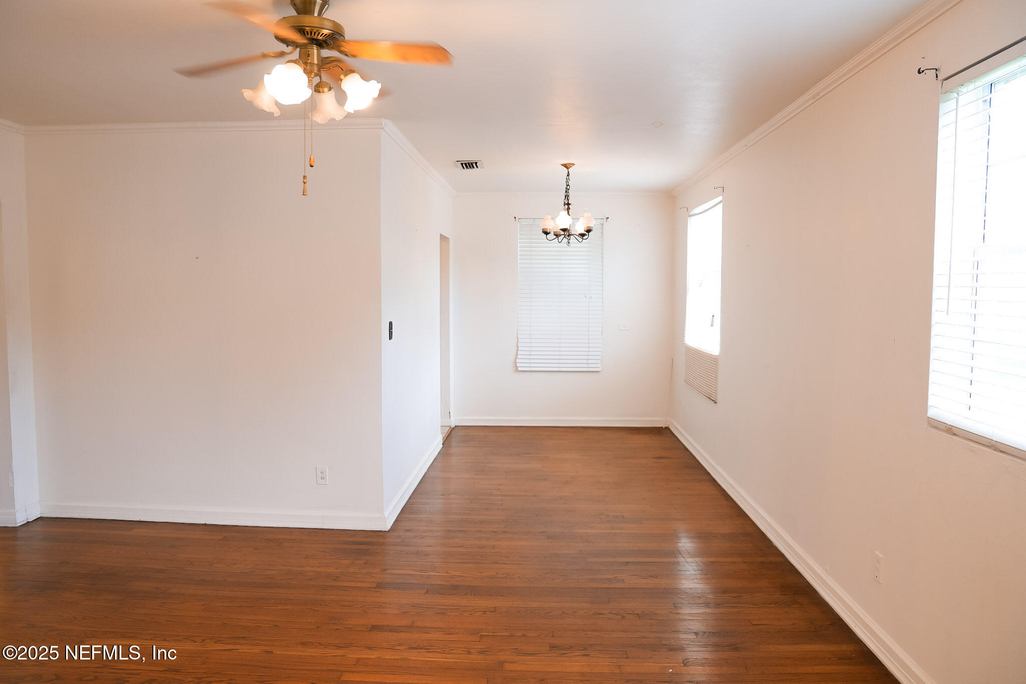 3224 Claremont Road Jacksonville, FL 32207 - Photo 5 of 26 an empty room with wooden floor fan and windows