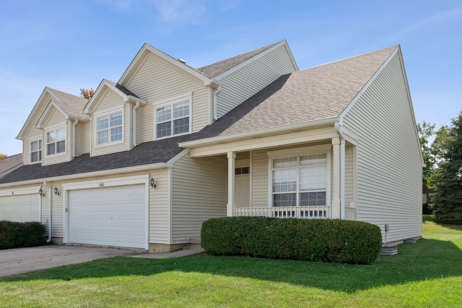a front view of a house with a garden