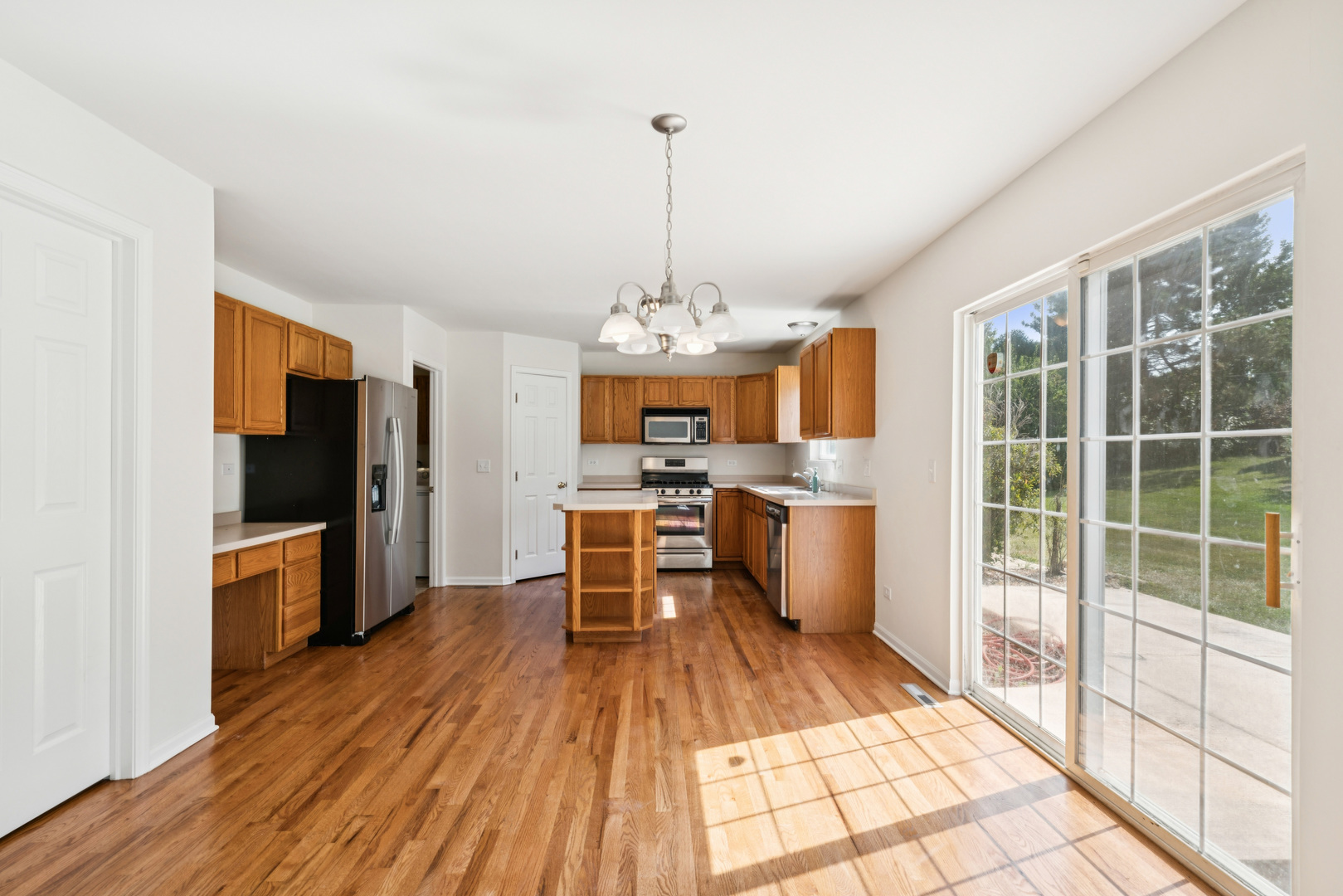 11683 Joan Avenue Huntley, IL 60142 - Photo 6 of 21 a very nice looking kitchen with granite countertop a large window and stainless steel appliances