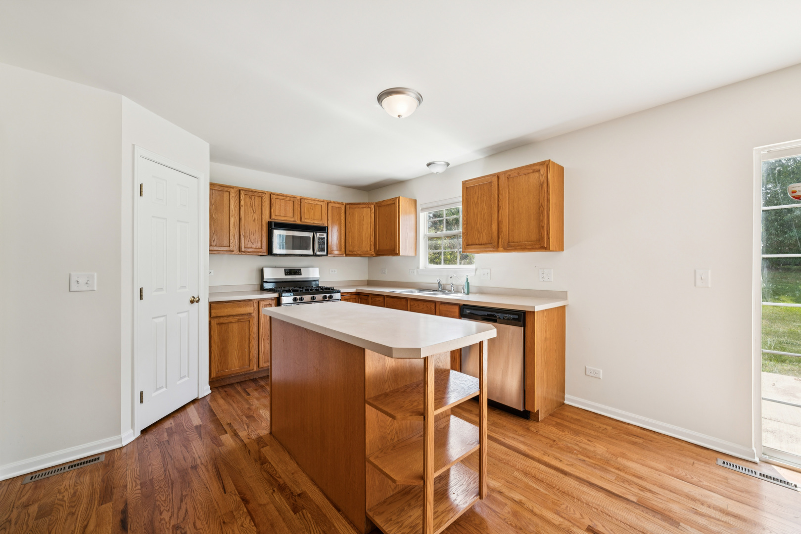11683 Joan Avenue Huntley, IL 60142 - Photo 8 of 21 a kitchen with granite countertop a sink cabinets and wooden floor