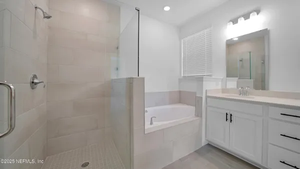 a bathroom with a granite countertop sink a toilet and a bathtub