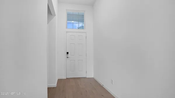a view of a kitchen with a sink and wooden floor