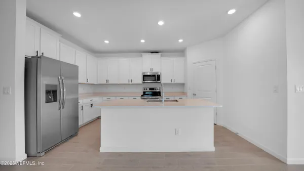 a kitchen with a sink appliances and cabinets