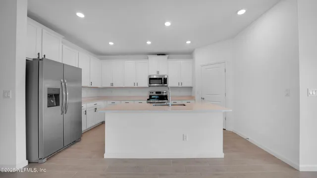 a kitchen with a sink appliances and cabinets