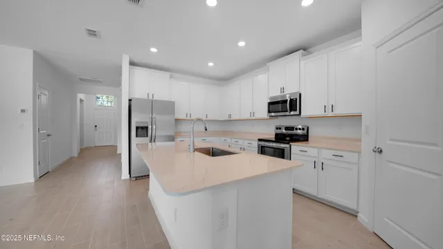 a kitchen with a sink stove and cabinets