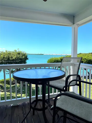 a view of a wooden chairs and table in patio