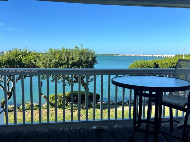 a view of balcony with wooden floor and seating space