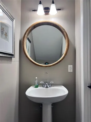 a bathroom with a sink and mirror