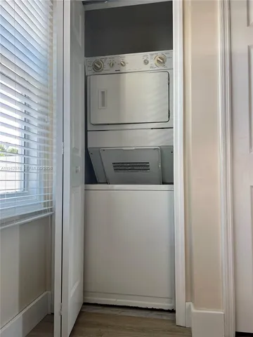 a room that has a wooden floor and a cabinet