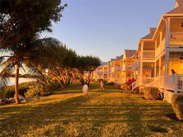 a view of a yard with wooden fence