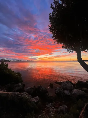 a view of large house with a yard and lawn chairs