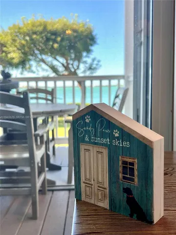 a view of a patio with table and chairs a barbeque with wooden floor and fence