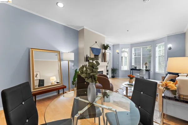 a living room with furniture a fireplace and a potted plant