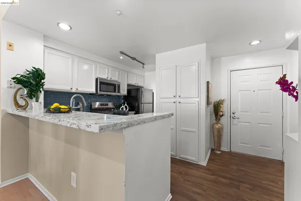 a kitchen with stainless steel appliances granite countertop a stove and a microwave
