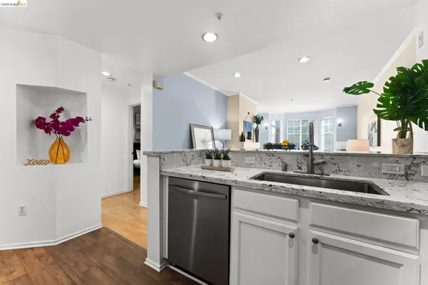 a living room with furniture and a dining table with kitchen view