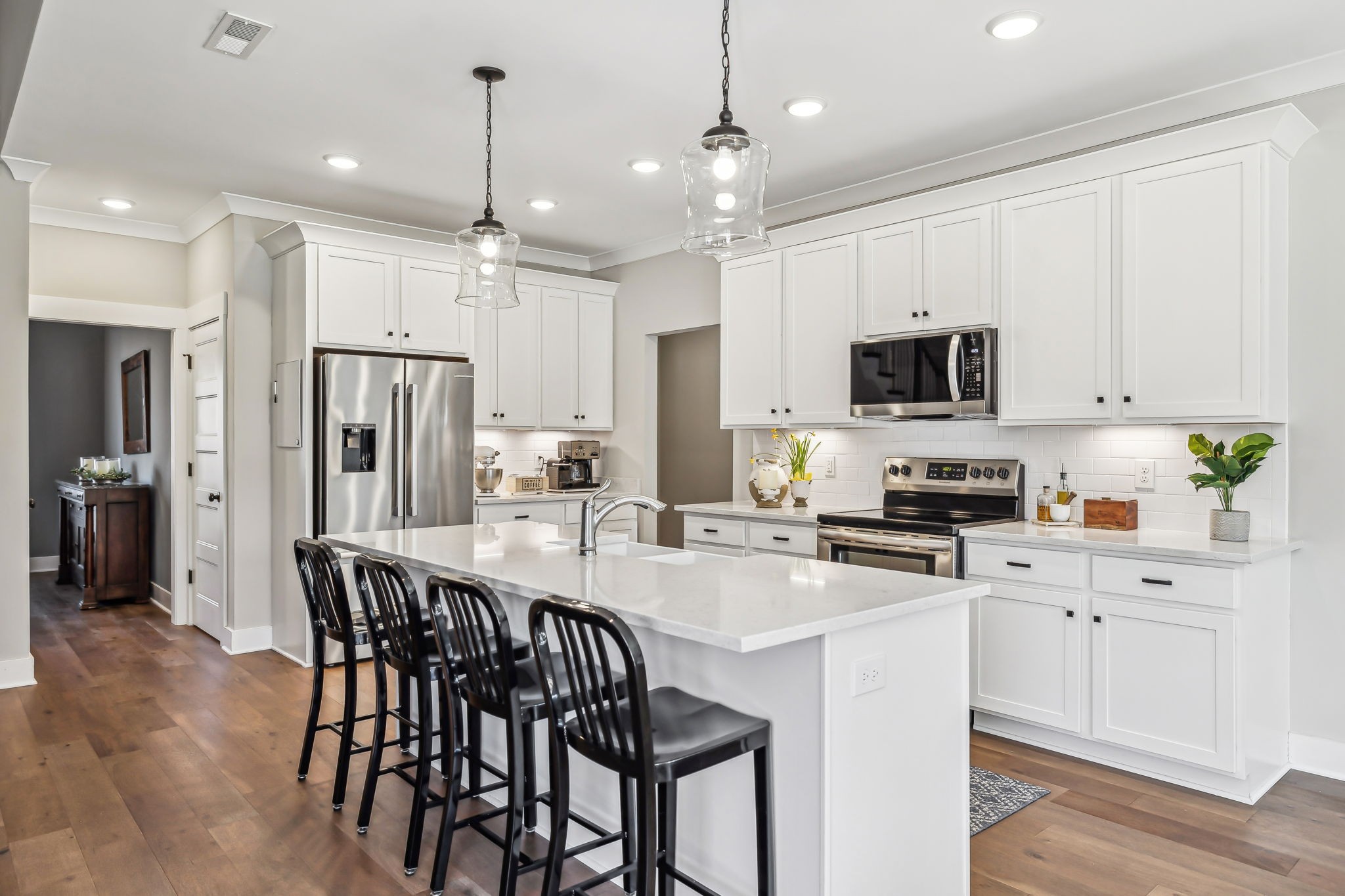 1567 Harrison Road Murfreesboro, TN 37128 - Photo 17 of 56 a kitchen with stainless steel appliances granite countertop a refrigerator a stove a sink a center island a dining table and chairs with wooden floor