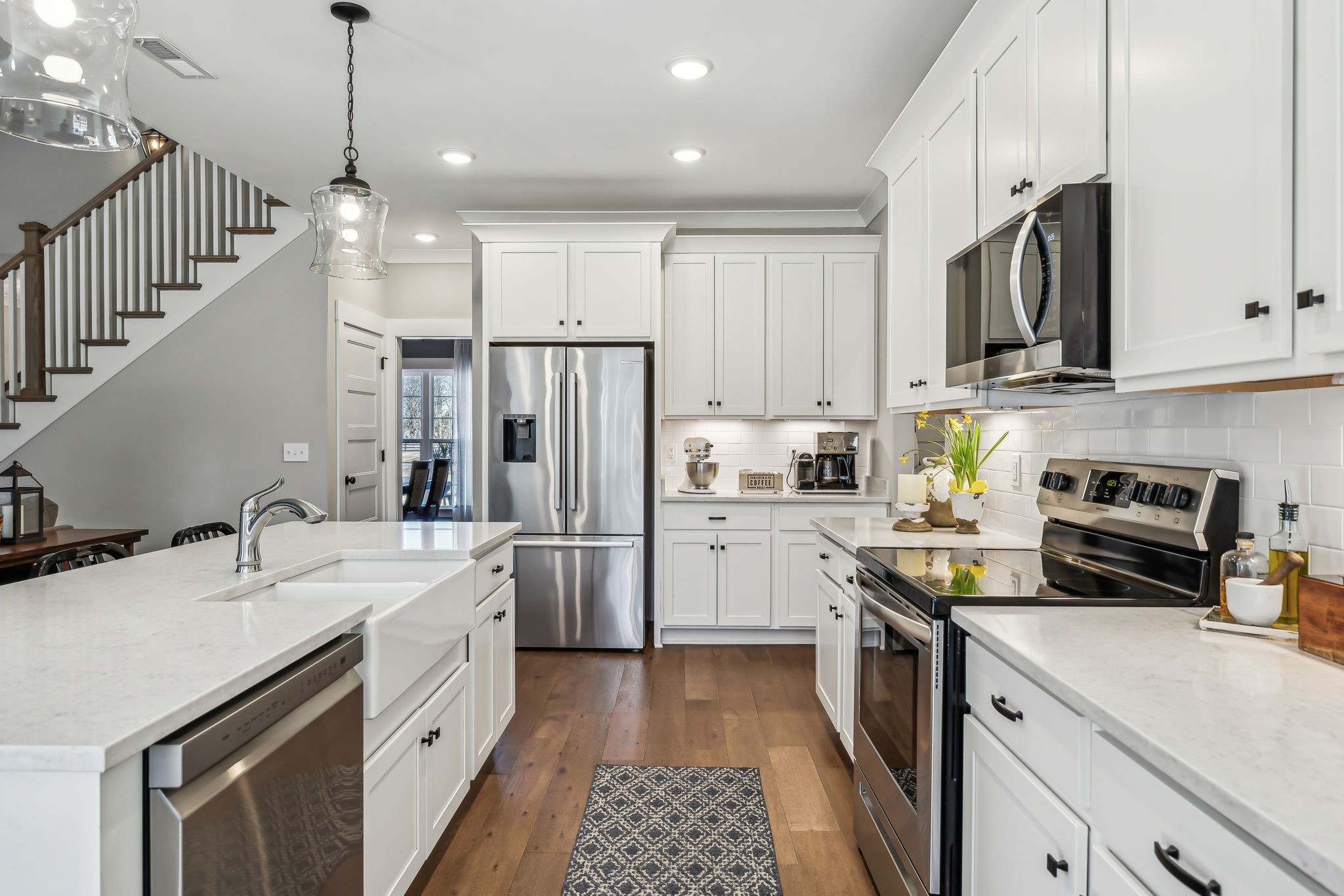 1567 Harrison Road Murfreesboro, TN 37128 - Photo 20 of 56 a kitchen with a sink a refrigerator a microwave and cabinets