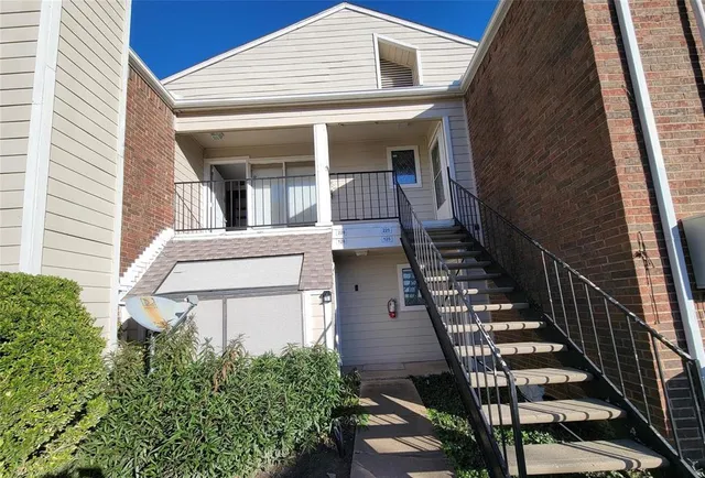 a view of a patio with table and chairs and wooden fence