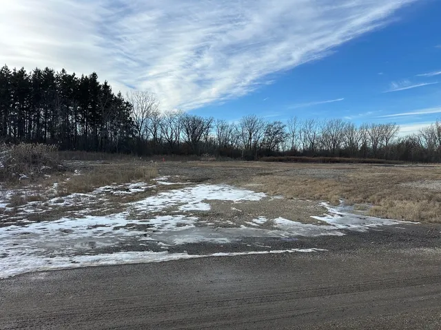 a view of a water pond with trees in the background