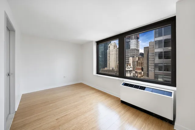 a view of a room with wooden floor and windows