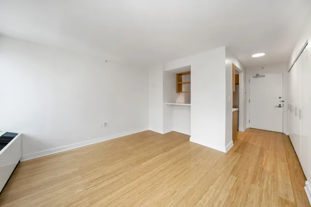 a view of hallway with wooden floor