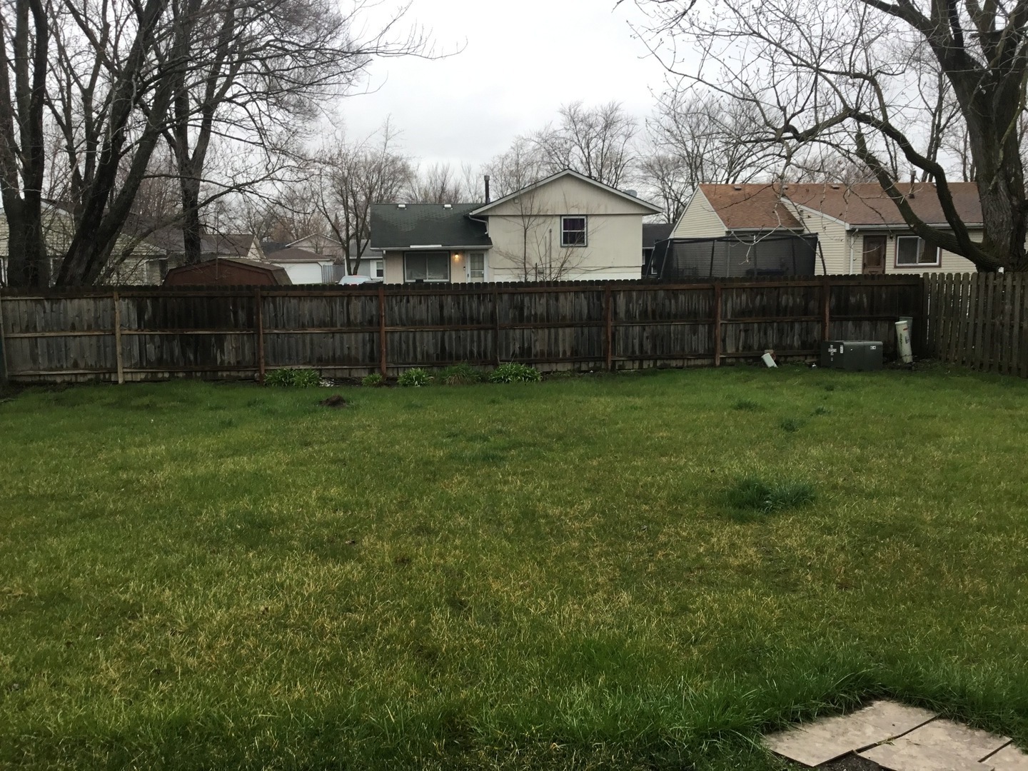 Undisclosed Address Richton Park, IL 60471 - Photo 11 of 11 a view of a backyard with wooden fence and a tree