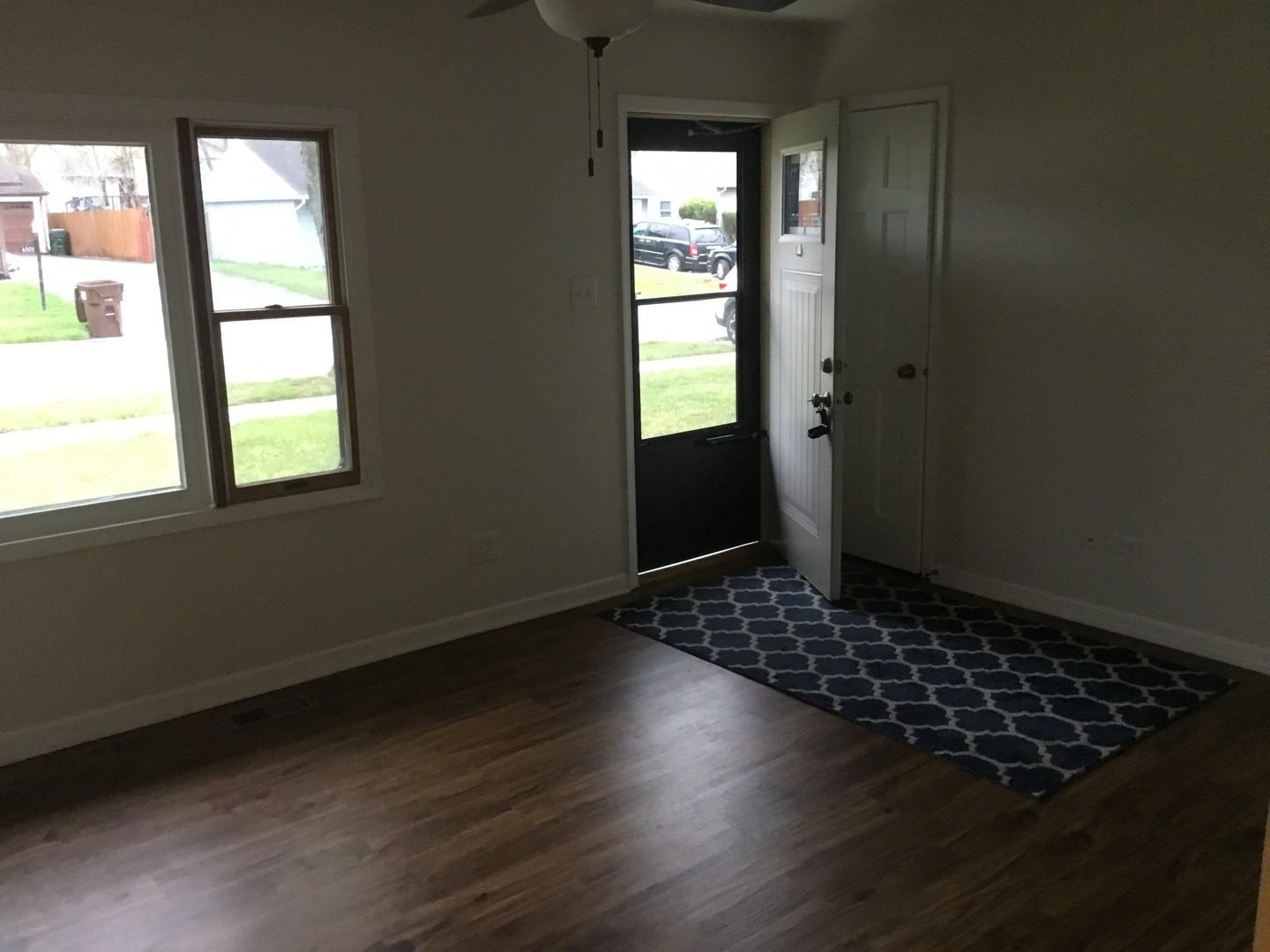 Undisclosed Address Richton Park, IL 60471 - Photo 4 of 11 an empty room with wooden floor and windows