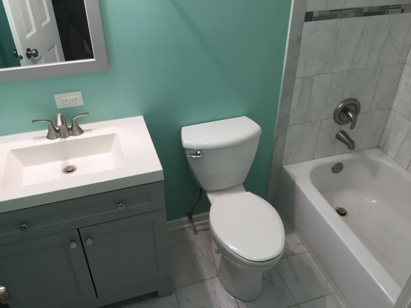 Undisclosed Address Richton Park, IL 60471 - Photo 8 of 11 a white toilet sitting next to a bathroom sink