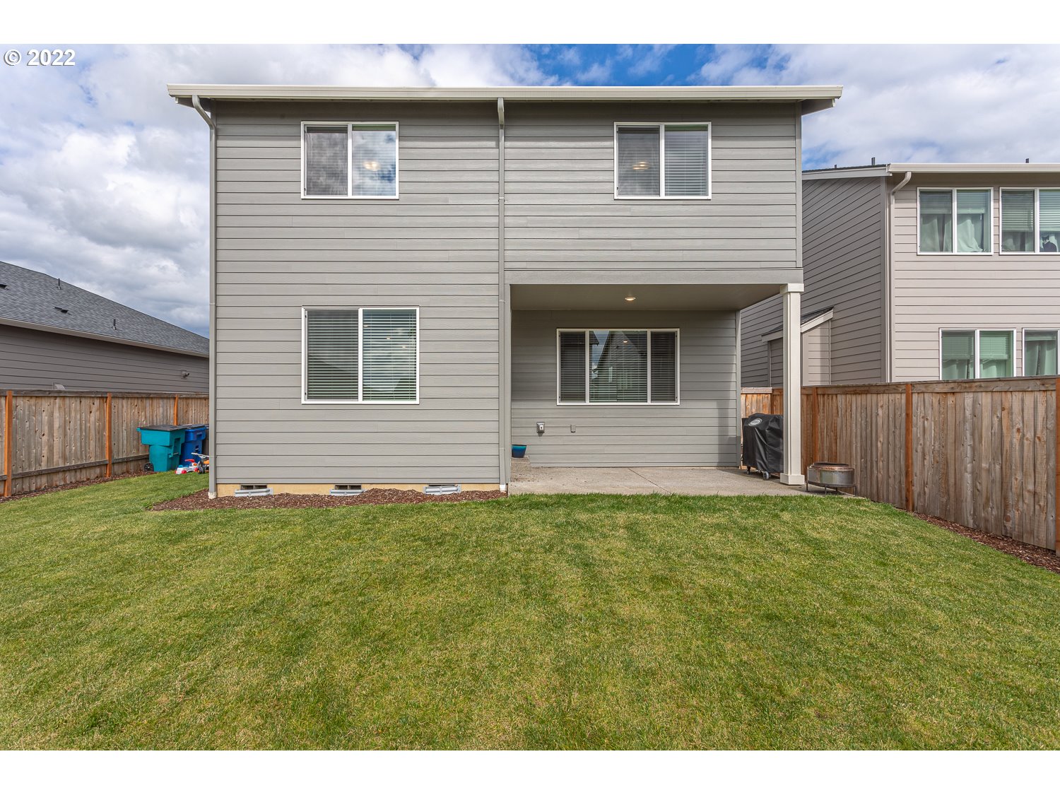3821 South 41st Place Ridgefield, WA 98642 - Photo 18 of 32 a backyard of a house with table and chairs