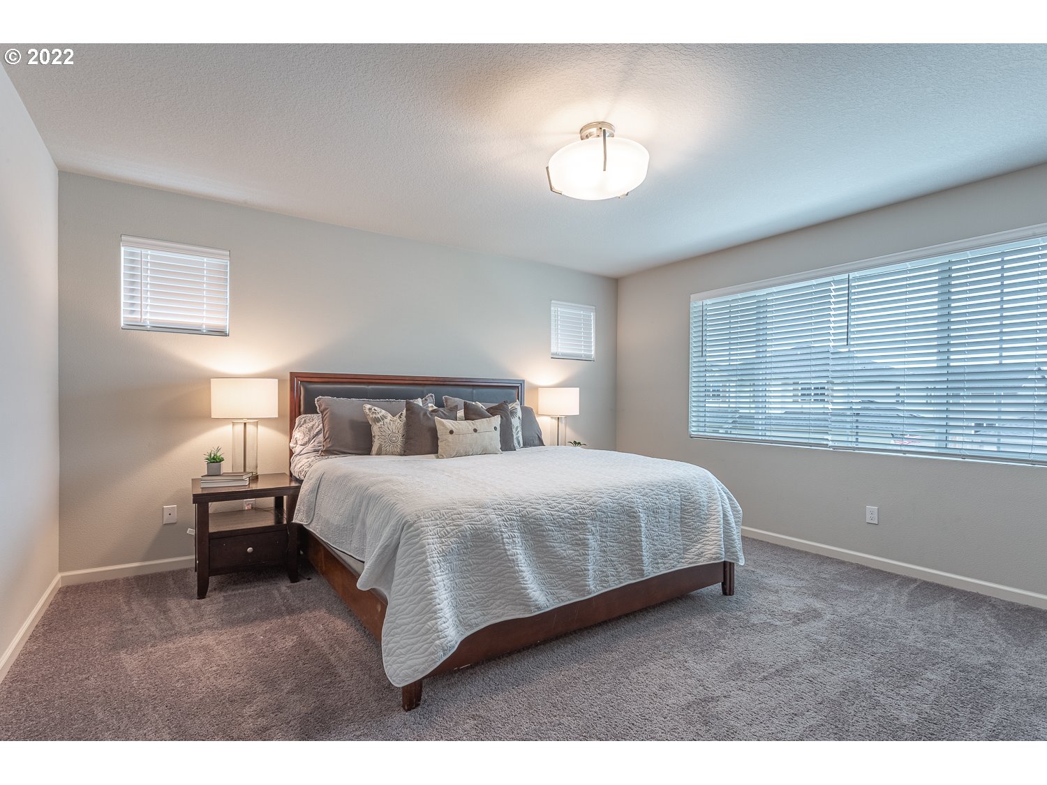 3821 South 41st Place Ridgefield, WA 98642 - Photo 22 of 32 a bedroom with a bed and a large window