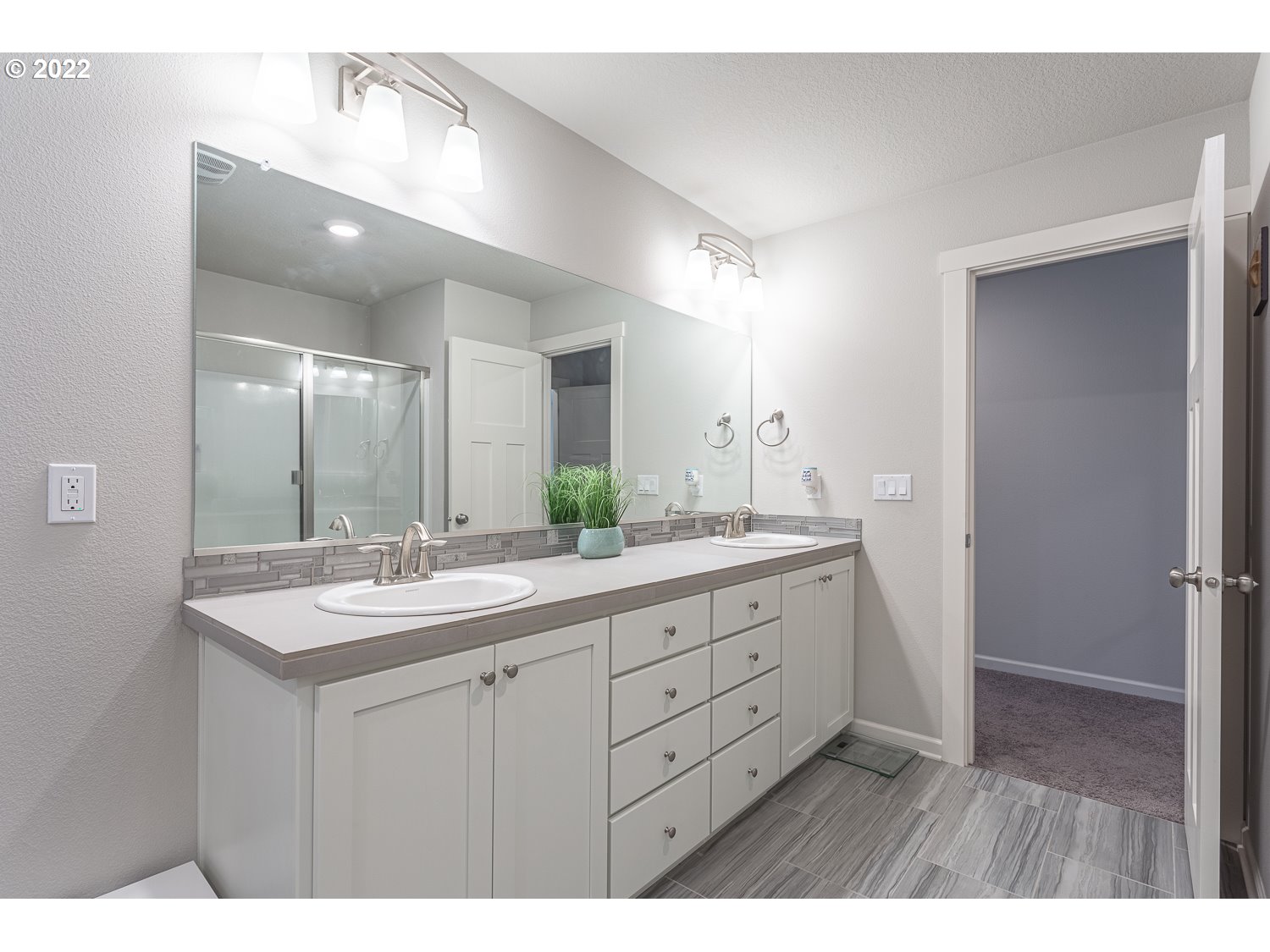 3821 South 41st Place Ridgefield, WA 98642 - Photo 24 of 32 a bathroom with a granite countertop sink a large mirror and a