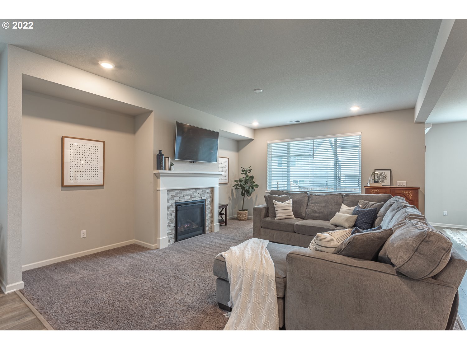3821 South 41st Place Ridgefield, WA 98642 - Photo 5 of 32 a living room with furniture a fireplace and a flat screen tv