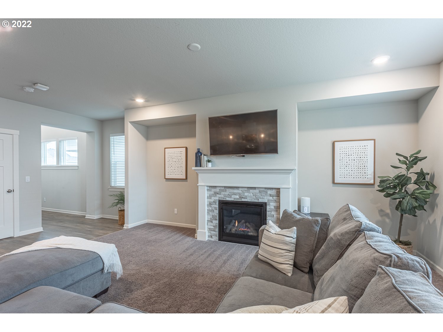3821 South 41st Place Ridgefield, WA 98642 - Photo 6 of 32 a living room with furniture a fireplace and a flat screen tv