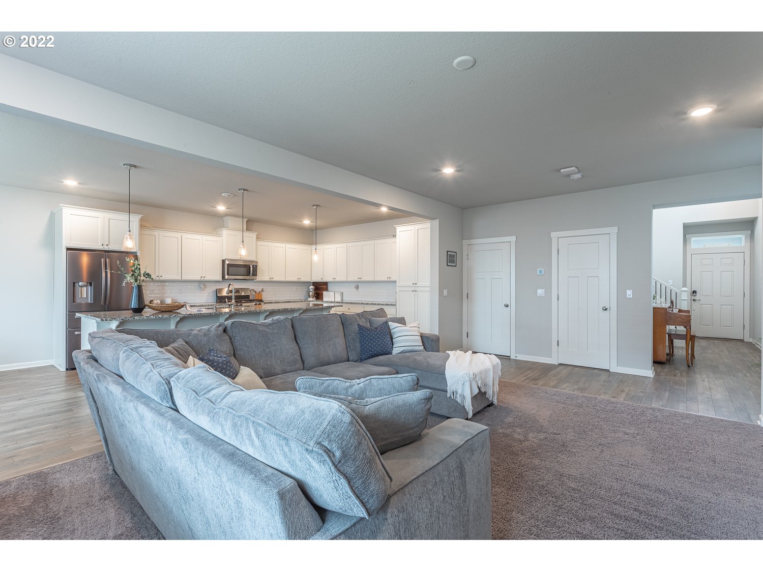 3821 South 41st Place Ridgefield, WA 98642 - Photo 7 of 32 a living room with furniture and a dining table with kitchen view