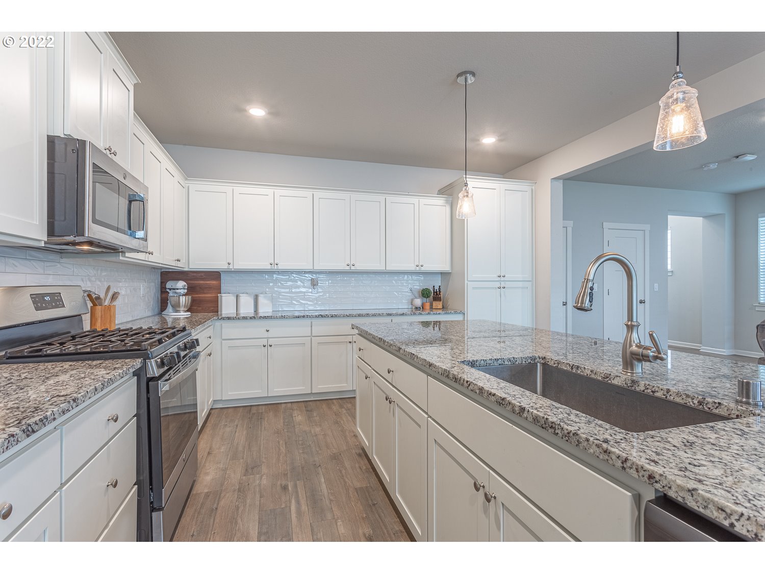 3821 South 41st Place Ridgefield, WA 98642 - Photo 9 of 32 a kitchen with granite countertop a sink stainless steel appliances and cabinets