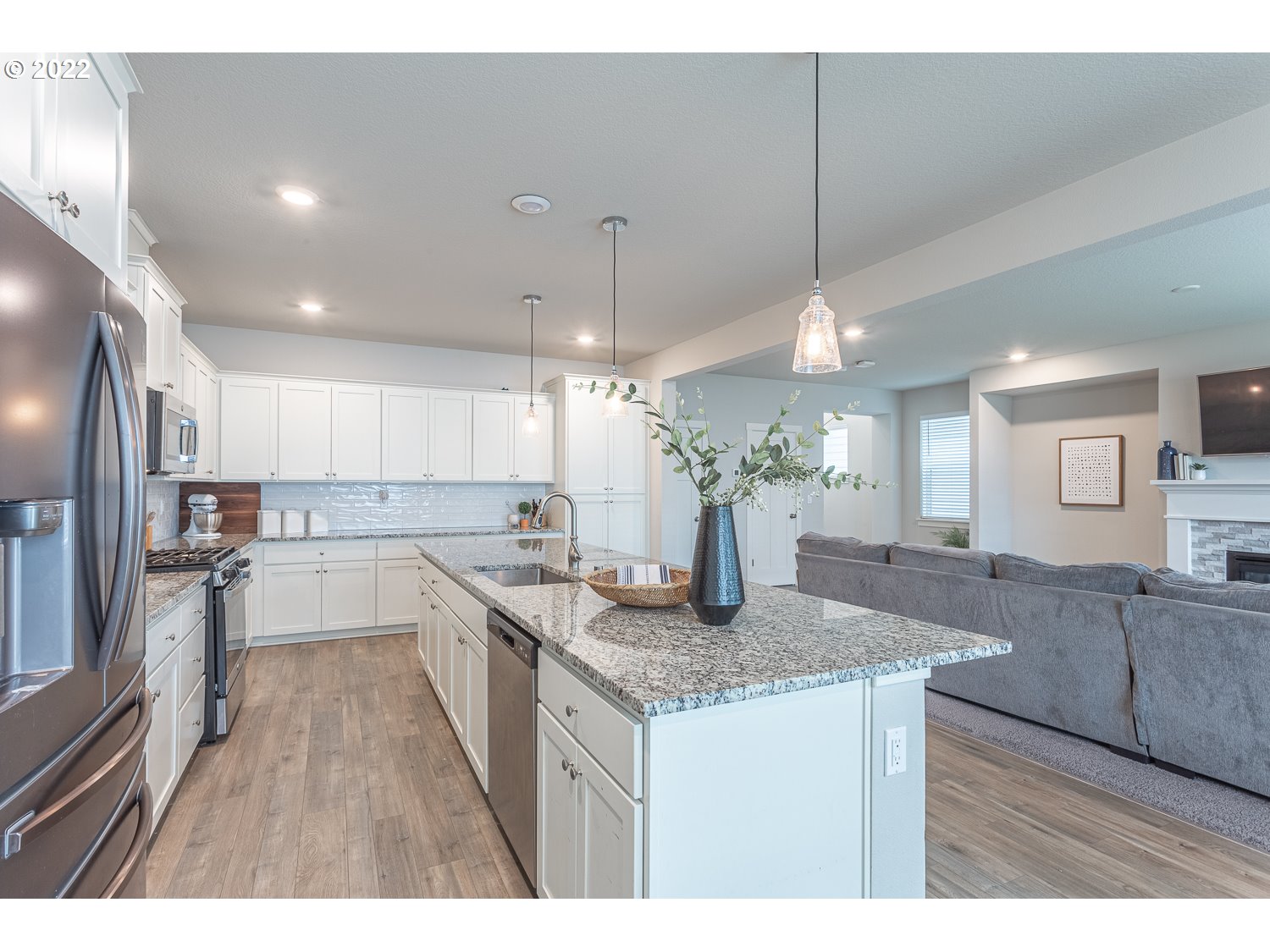 3821 South 41st Place Ridgefield, WA 98642 - Photo 10 of 32 a kitchen with stainless steel appliances granite countertop wooden cabinets a stove a sink a dining table and chairs