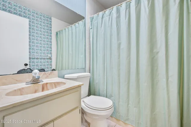 a bathroom with a sink a toilet and tub