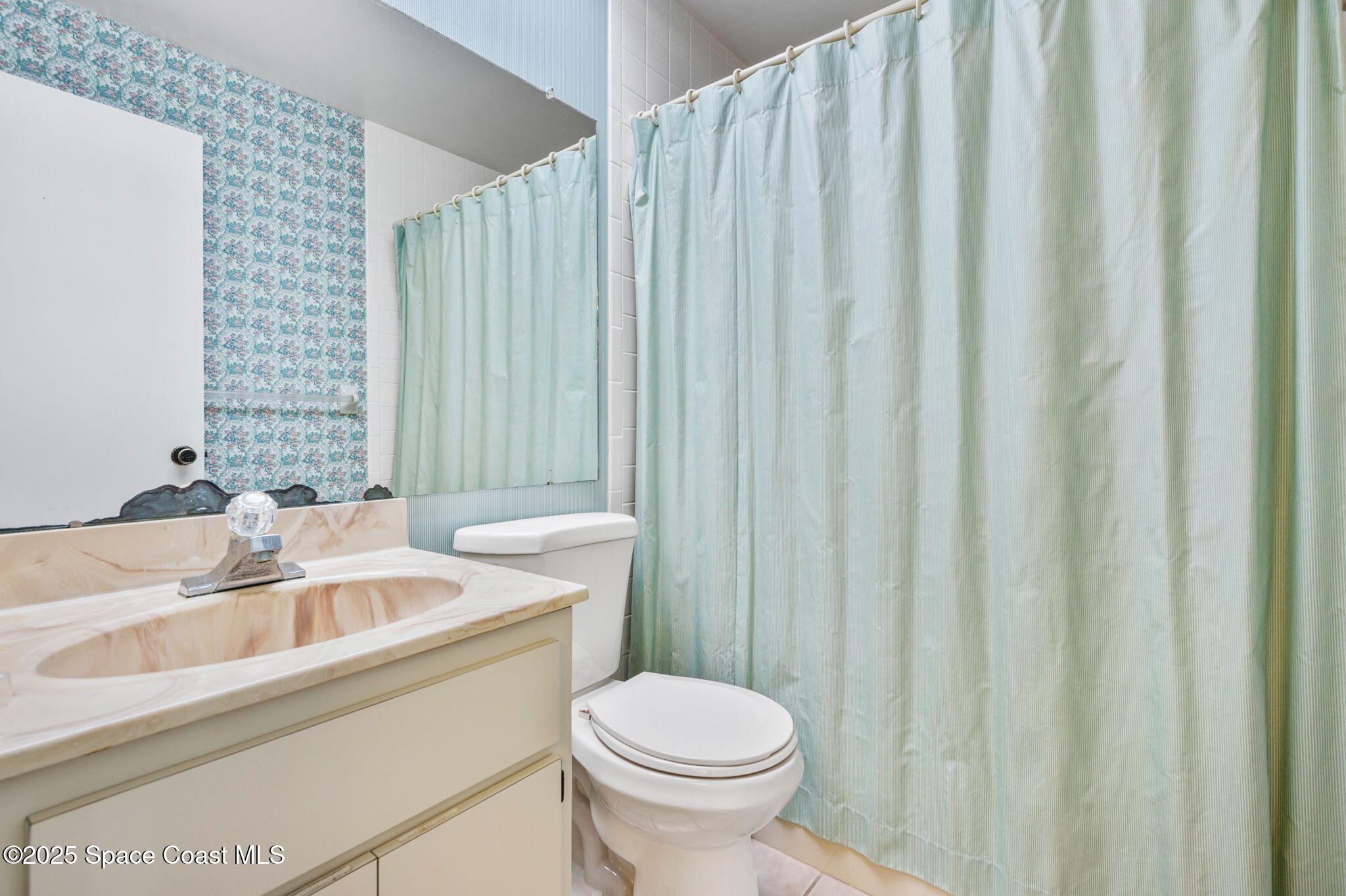 200 South Banana River Boulevard, Unit 2424 Cocoa Beach, FL 32931 - Photo 13 of 18 a bathroom with a sink a toilet and tub